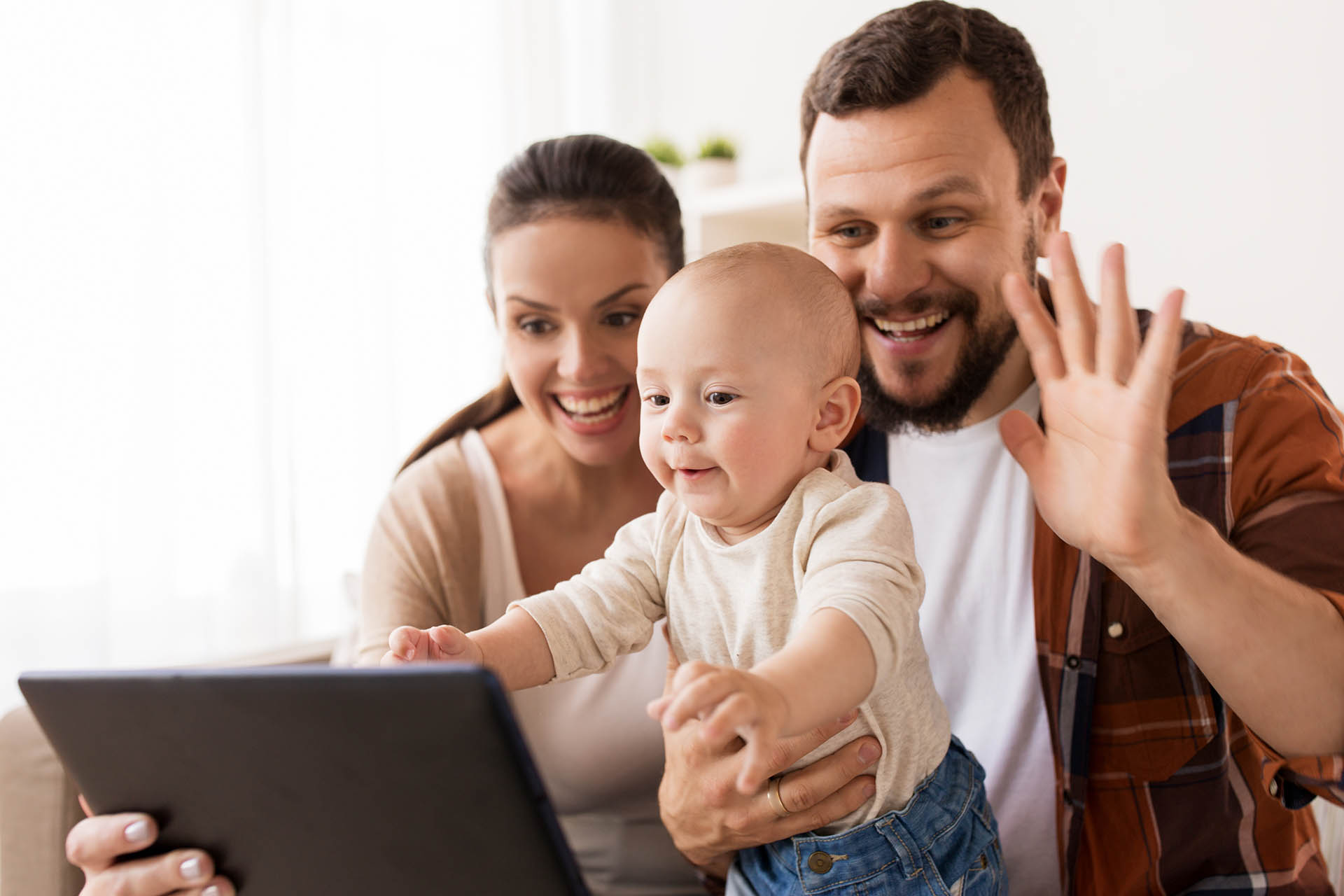 mother, father and baby with tablet pc at home